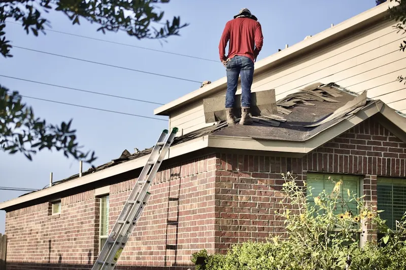 Professional roofer working on a residential roof in Orchard Trail